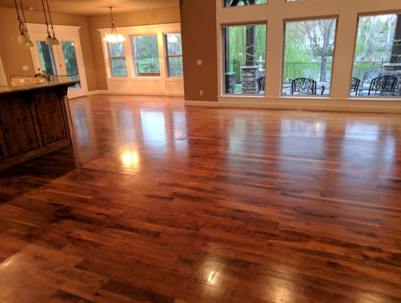 Finished hardwood flooring in a bright Birmingham, Alabama home with an open kitchen and dining area