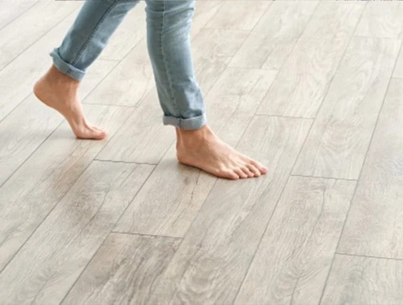 Birmingham AL laminate flooring installation with a person walking across light wood-look planks