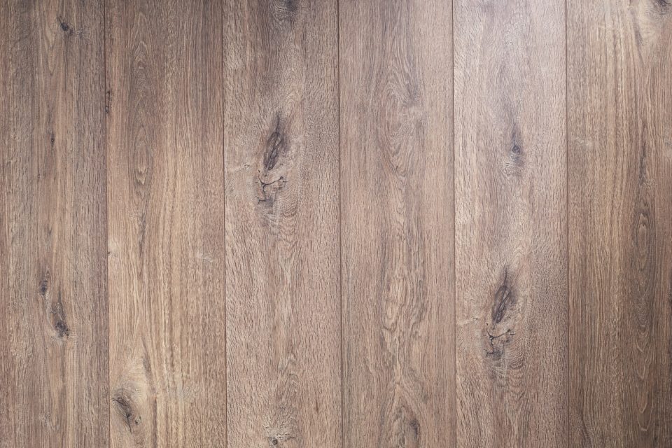 Wood-look laminate flooring with natural grain and plank variation