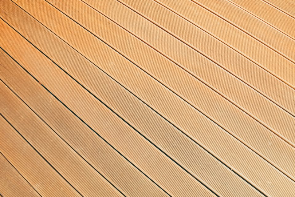 Close-up of warm-toned wooden flooring planks, illustrating hardwood flooring options.